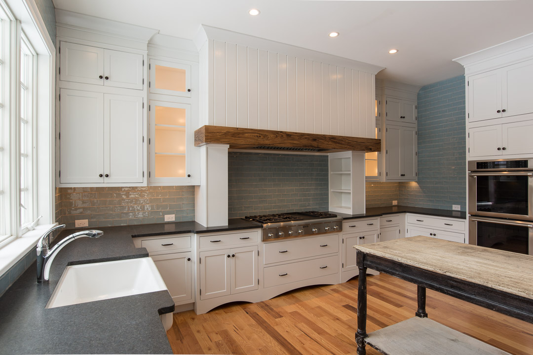 Berwyn Nantucket custom home kitchen with built-in range and hood - american farmhouse interior design