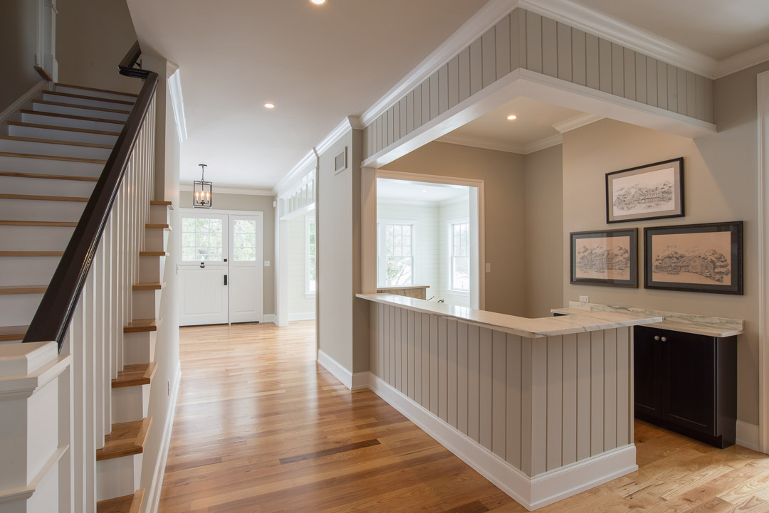 Berwyn Nantucket custom home foyer with staircase and custom bar