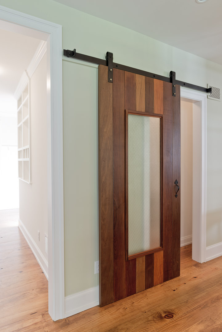 Winslow Interiors - space planning - sliding wood panel pantry door