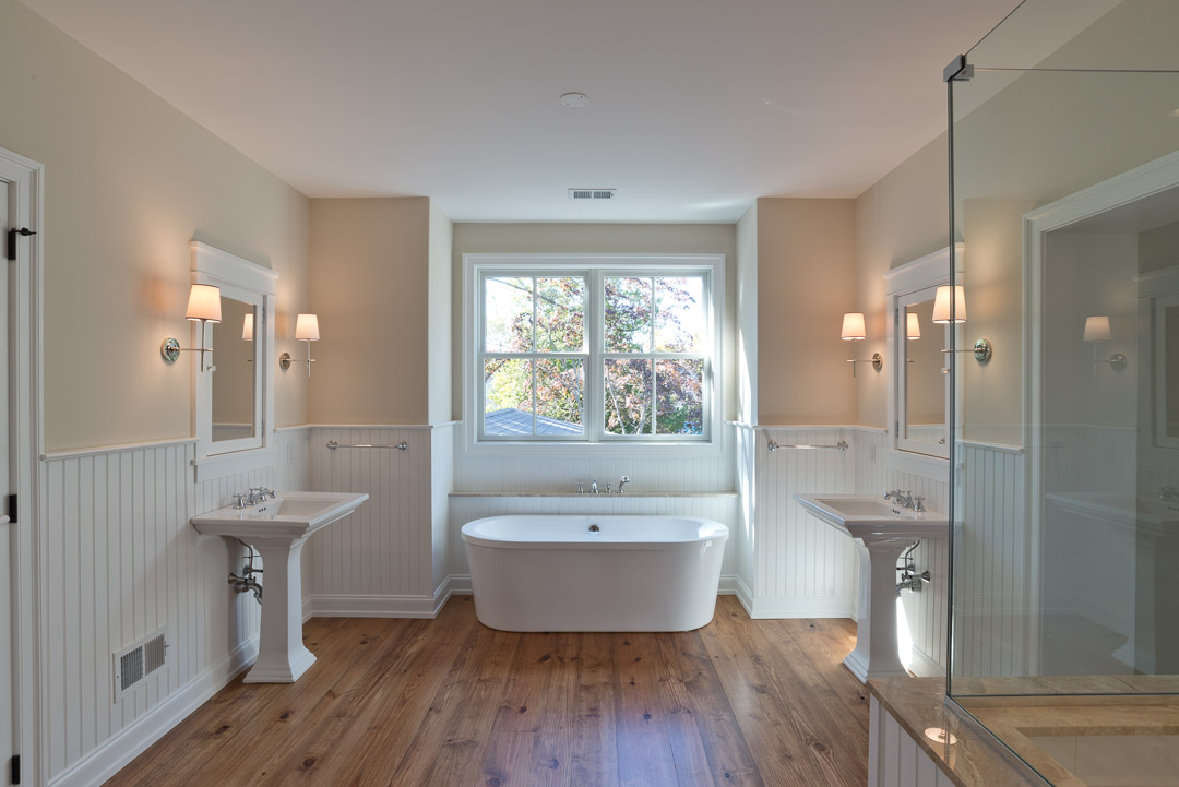 New american farmhouse bathroom with dual sinks and standalone tub
