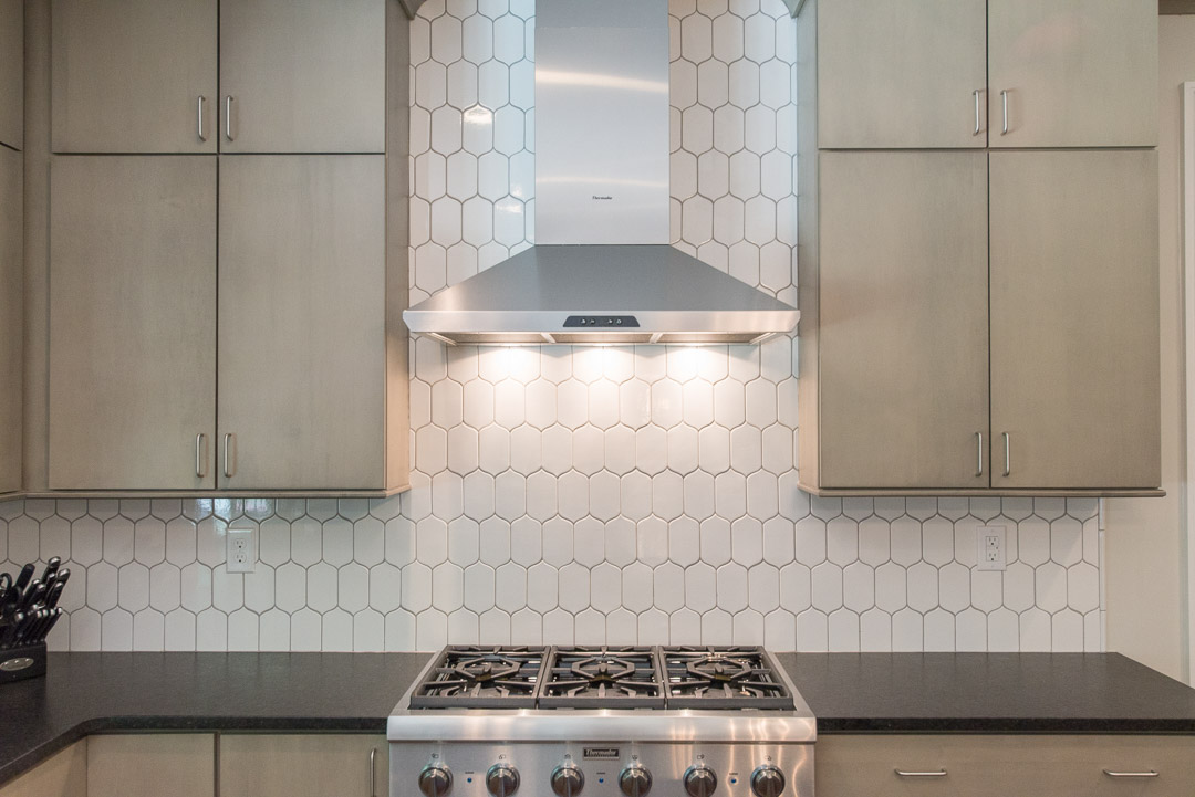 Newtown Square custom home kitchen with built-in range and custom tile backsplash