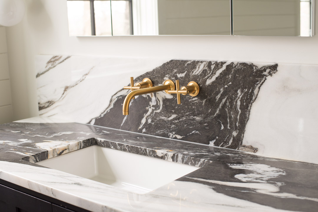 Marble bathroom vanity with brass faucet
